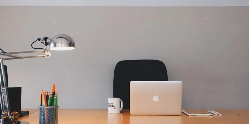 silver apple macbook on brown wooden table