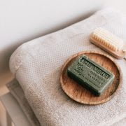 natural soap and brush on folded towels