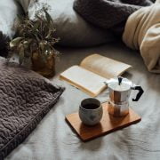 coffee and book on comfortable bed
