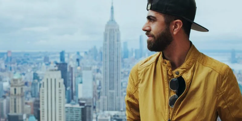 portrait photo of man in yellow zip up jacket near empire state building