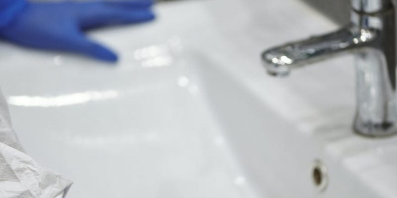 person sanitizes lavatory